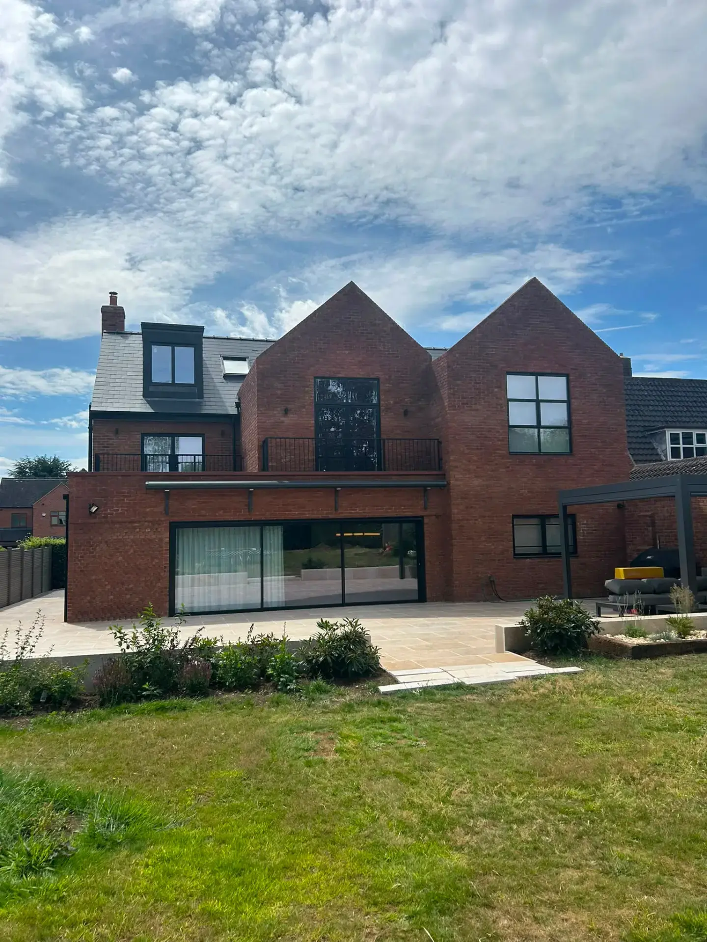 Large red-brick detached home in Derby with black-framed glazing, smart lighting and electrical installation by R Electrical Solutions